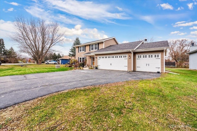 front facade featuring a garage and a front lawn