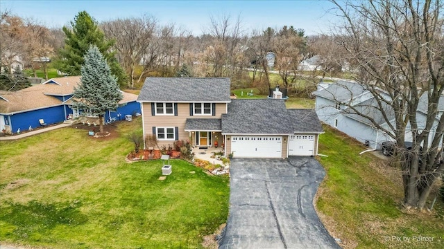 view of front of property with a front lawn and a garage