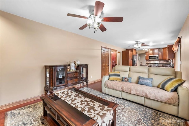 living room featuring hardwood / wood-style floors and ceiling fan