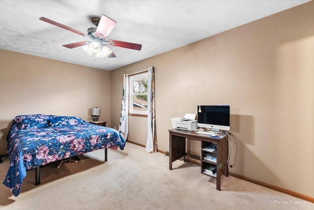 bedroom featuring ceiling fan and light carpet