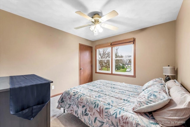 carpeted bedroom with ceiling fan