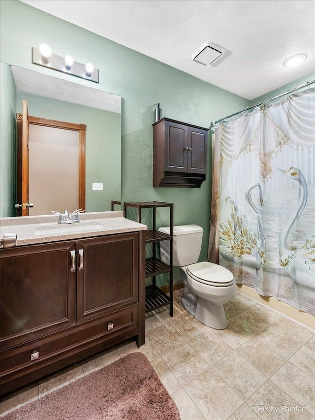 full bathroom featuring toilet, shower / bath combo, vanity, and tile patterned floors