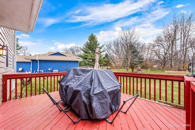 wooden deck with grilling area and a yard