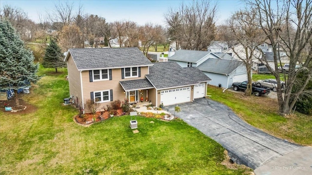 view of front of property featuring a front lawn and a garage