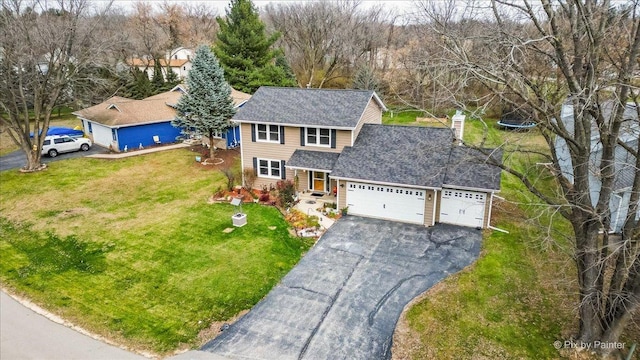 view of front facade featuring a front yard and a garage