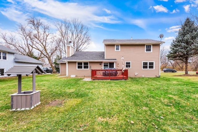 rear view of house featuring a yard and a deck