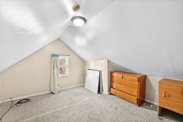 additional living space with lofted ceiling and light carpet