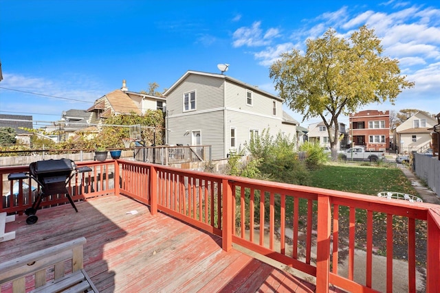 deck with a lawn and a grill