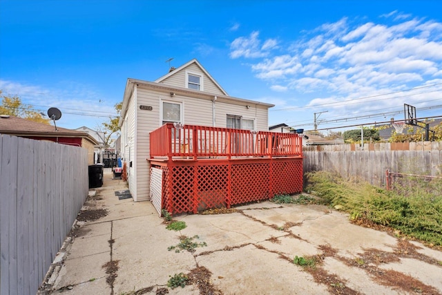 rear view of property featuring a deck