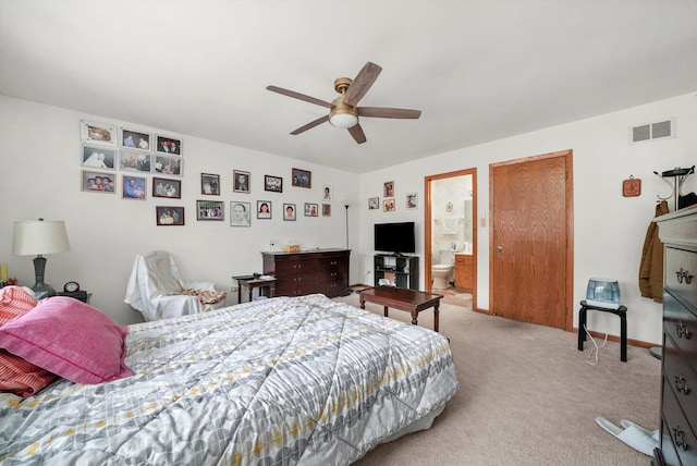 carpeted bedroom featuring ensuite bath and ceiling fan