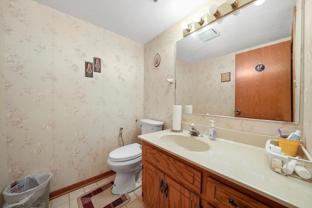 bathroom featuring toilet, vanity, and tile patterned floors