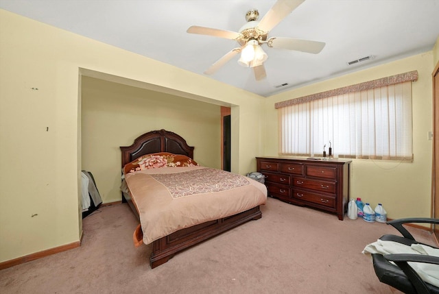 bedroom featuring light colored carpet and ceiling fan