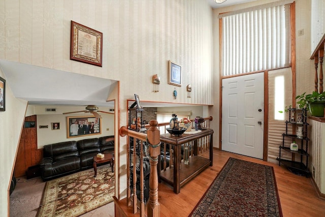 foyer entrance with ceiling fan and light hardwood / wood-style flooring