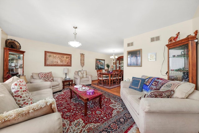 living room with wood-type flooring and an inviting chandelier