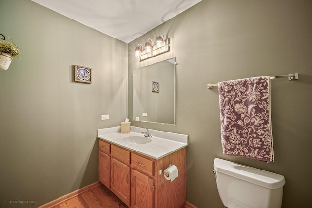 bathroom featuring hardwood / wood-style floors, toilet, and vanity