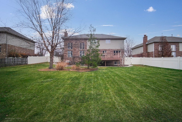 back of house featuring a wooden deck and a yard