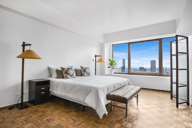 bedroom featuring dark parquet flooring