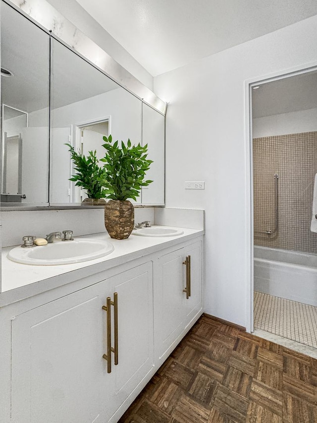 bathroom with vanity, parquet floors, and tub / shower combination