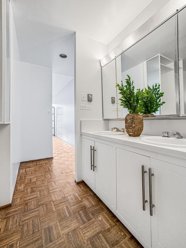 bathroom with vanity and parquet flooring