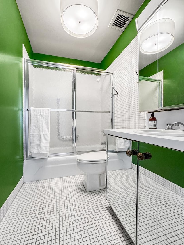 bathroom with tile patterned floors, toilet, and sink