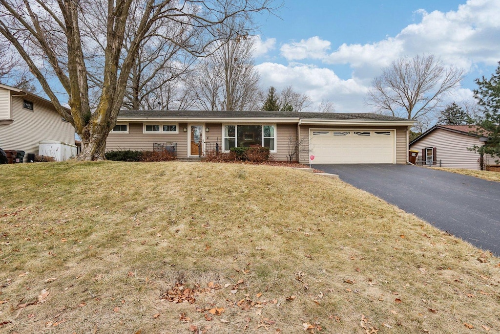 ranch-style house with a front lawn and a garage