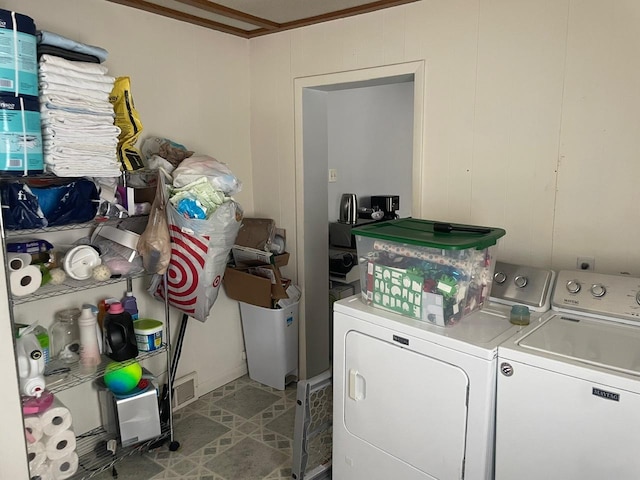 laundry area with washer and clothes dryer and ornamental molding