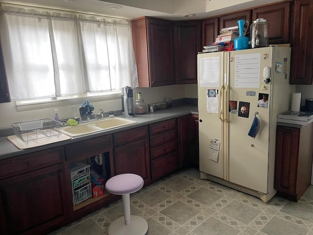 kitchen with white fridge with ice dispenser and sink