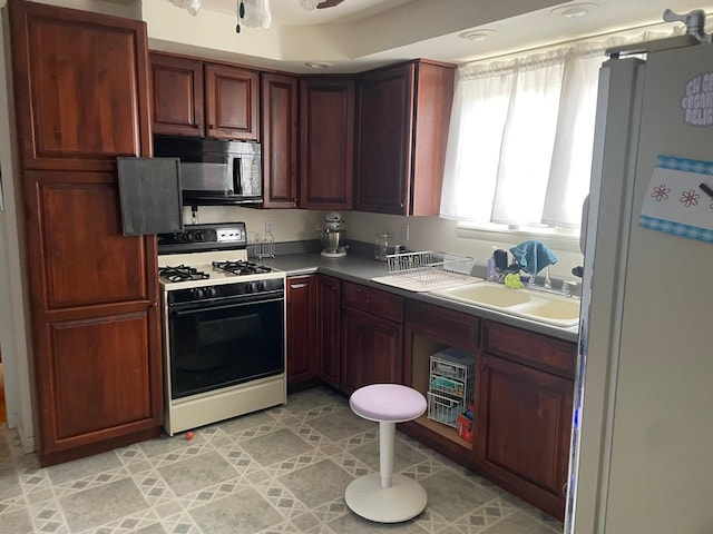 kitchen featuring sink and white appliances