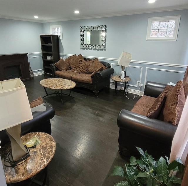 living room with dark hardwood / wood-style floors and crown molding