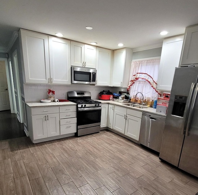 kitchen featuring sink, white cabinetry, and appliances with stainless steel finishes