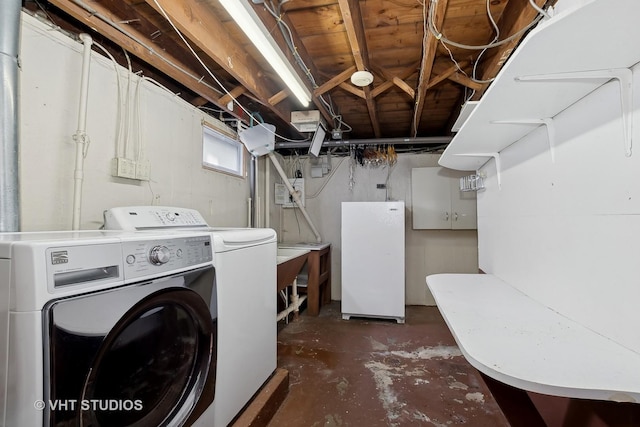 clothes washing area with separate washer and dryer