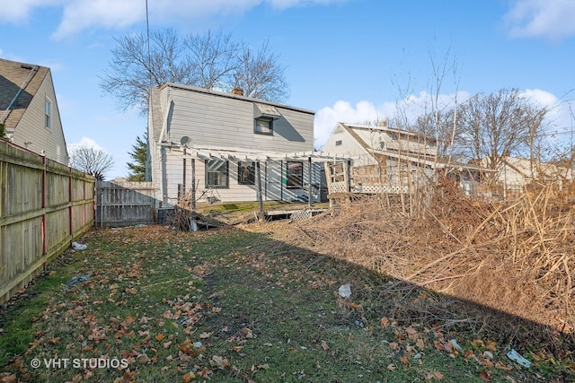 rear view of property featuring a pergola