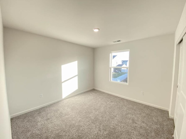 unfurnished bedroom featuring carpet flooring and a closet