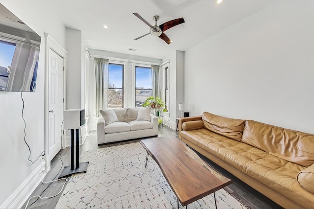 living room with ceiling fan and wood-type flooring