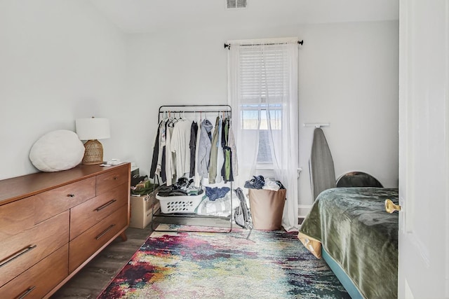 bedroom with dark hardwood / wood-style flooring