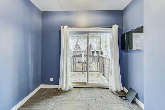 doorway to outside featuring carpet floors