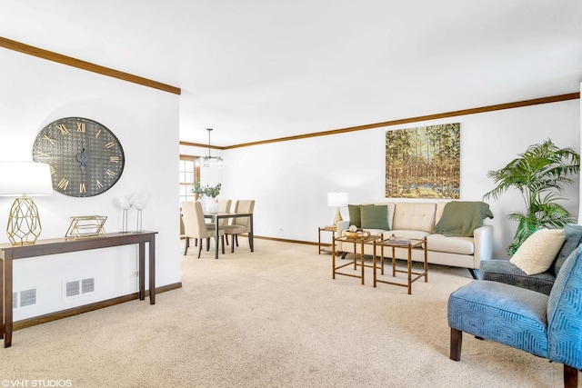 carpeted living room featuring crown molding and a chandelier