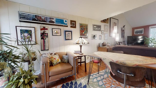 living room featuring wood-type flooring and lofted ceiling