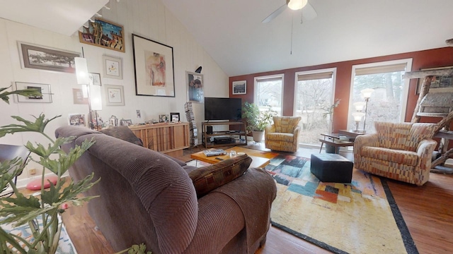 living room featuring ceiling fan, hardwood / wood-style floors, and high vaulted ceiling