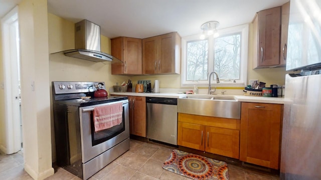 kitchen featuring light tile patterned flooring, sink, stainless steel appliances, and wall chimney range hood