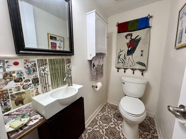 bathroom featuring tile patterned floors, vanity, and toilet