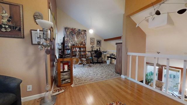 hallway with high vaulted ceiling and wood-type flooring