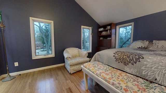 bedroom featuring hardwood / wood-style floors and lofted ceiling