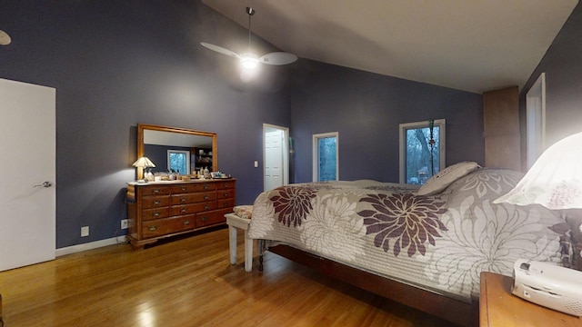 bedroom featuring ceiling fan, hardwood / wood-style floors, and high vaulted ceiling