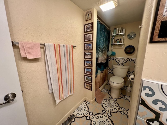 bathroom with tile patterned floors and toilet