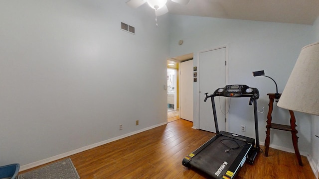 exercise area with ceiling fan, hardwood / wood-style floors, and lofted ceiling