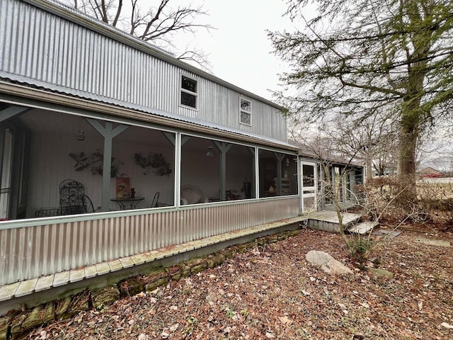 view of side of property featuring a sunroom