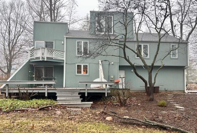 back of property featuring a balcony