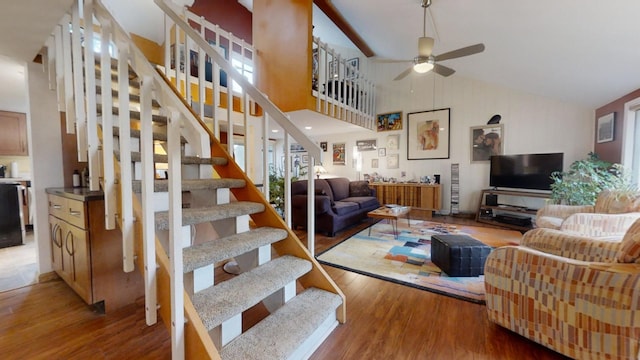 living room featuring light hardwood / wood-style floors, high vaulted ceiling, and ceiling fan