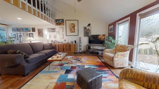 living room featuring hardwood / wood-style floors and vaulted ceiling